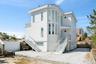 Back of property with stucco siding and stairs