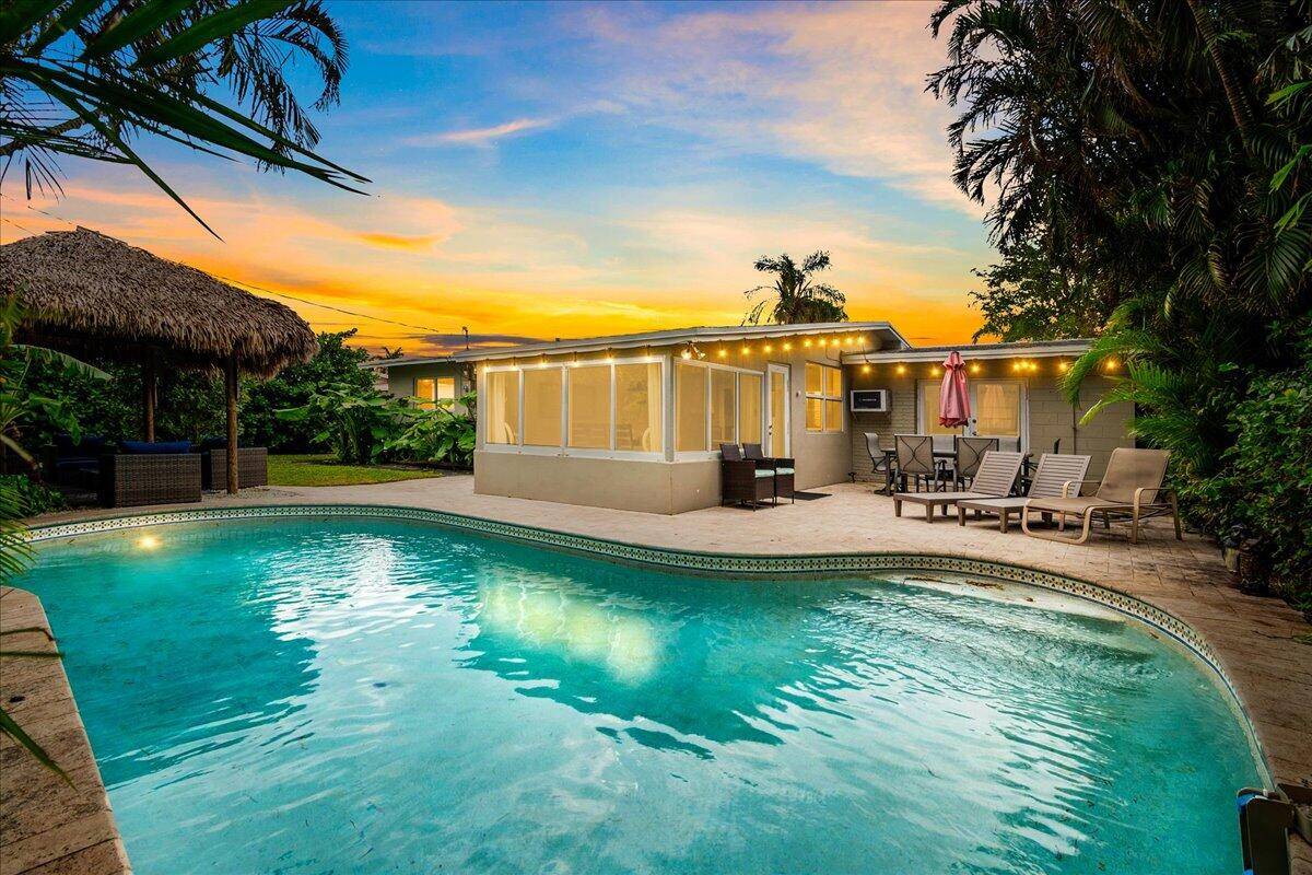 This home is a tropical, turn key paradise, just one block from the intracoastal and multi million dollar homes !