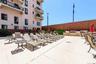 View of pool deck with BBQs