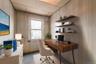 Office with a paneled ceiling, wooden walls, and light carpet