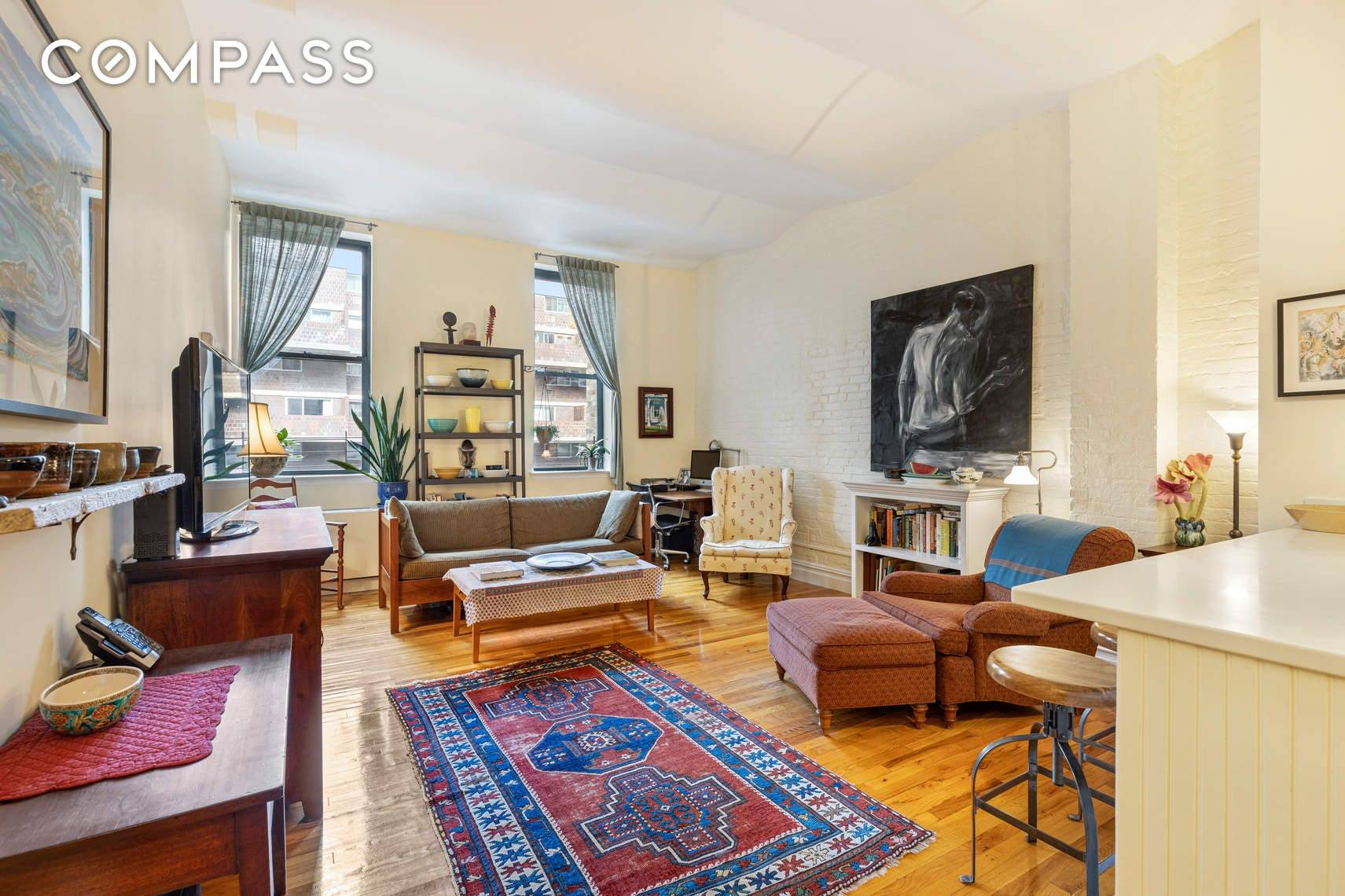 This expansive two bedroom, two bath home has a terrific layout featuring soaring barrel vaulted ceilings and white exposed brick walls.