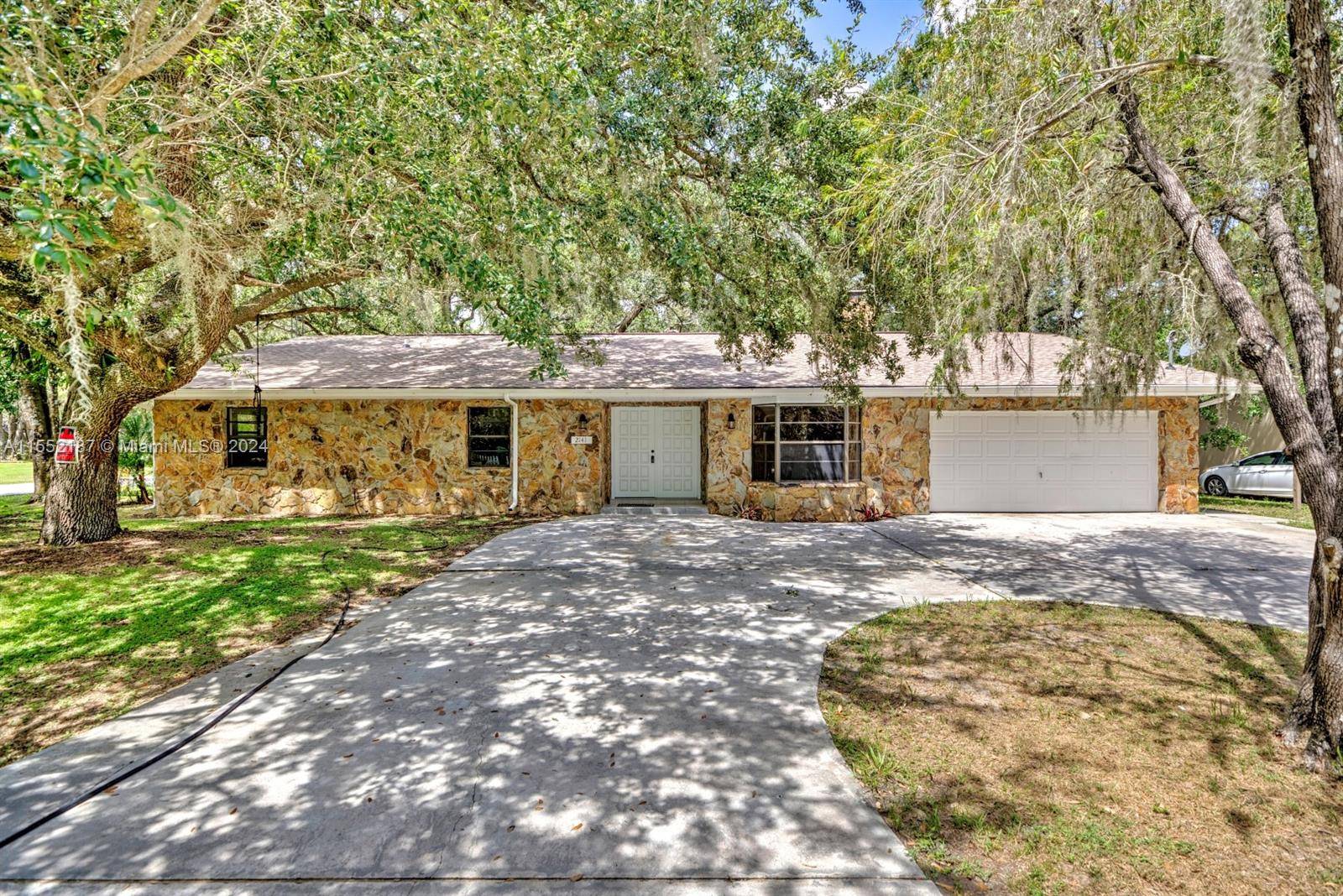 A spacious corner lot surrounded by mature trees on a lush Oak Canopied Tree Lined Street.