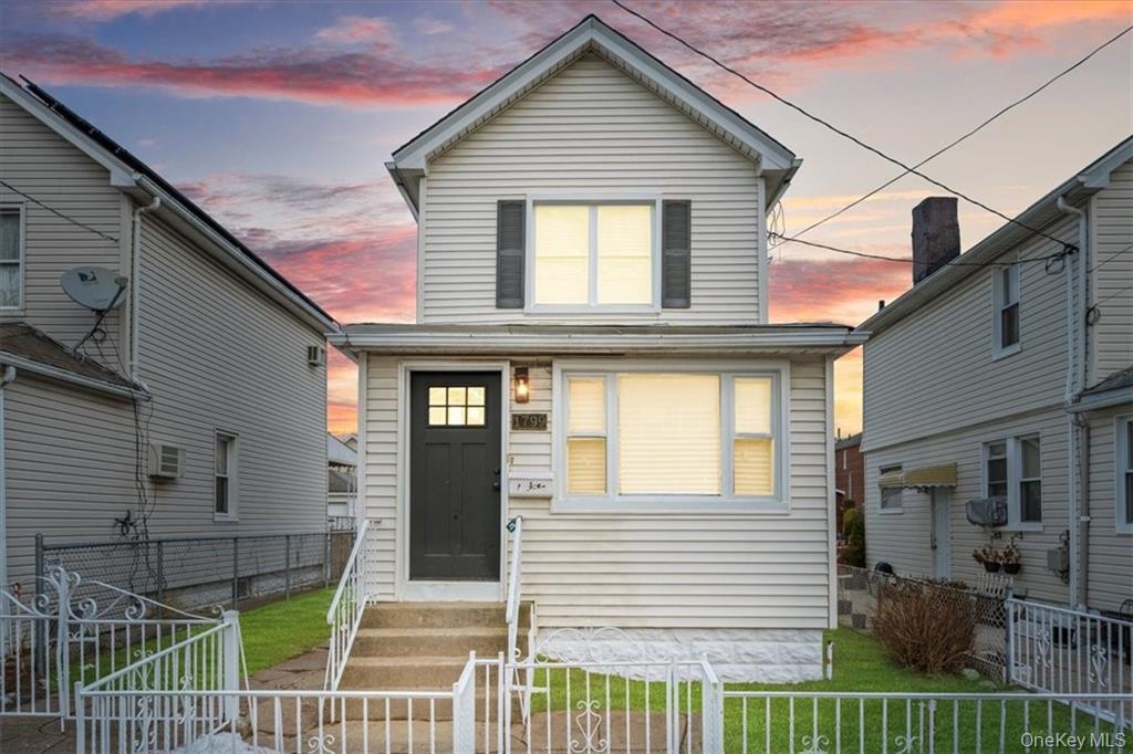 View of front of house with a fenced front yard and entry steps