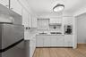 Kitchen with window over sink, new appliances, new luxury vinyl flooring and freshly painted.