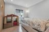 Light gray painted walls with white crown molding, electric blinds