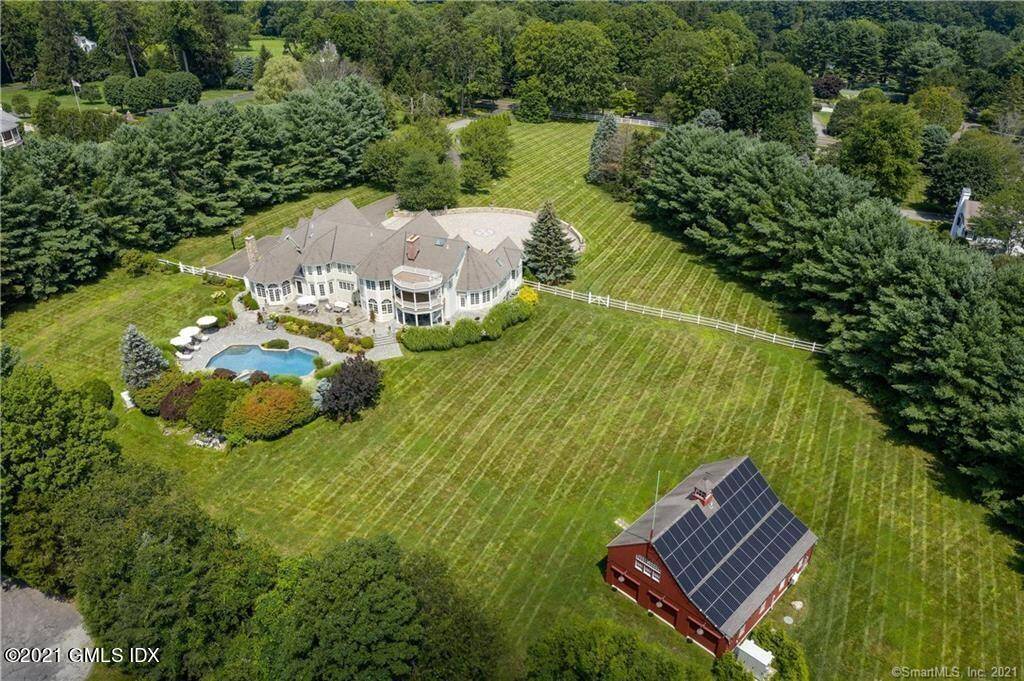 Majestically sited estate on one of the highest points in New Canaan, prestigious Oenoke Ridge, offering seasonal views of the Manhattan skyline.