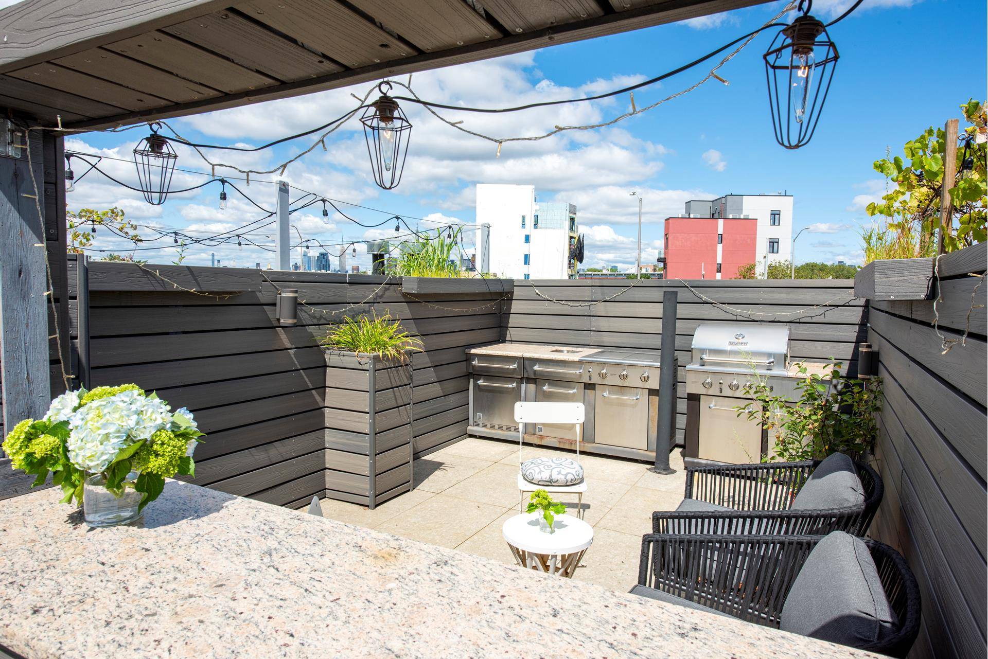 Sweeping Brooklyn and Manhattan skyline views will take your breath away from the private rooftop cabana of this gorgeous modern condo in Williamsburg.