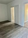 Empty room with light hardwood / wood-style floors
