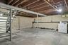 Unfinished Basement featuring clothes dryer high ceilings