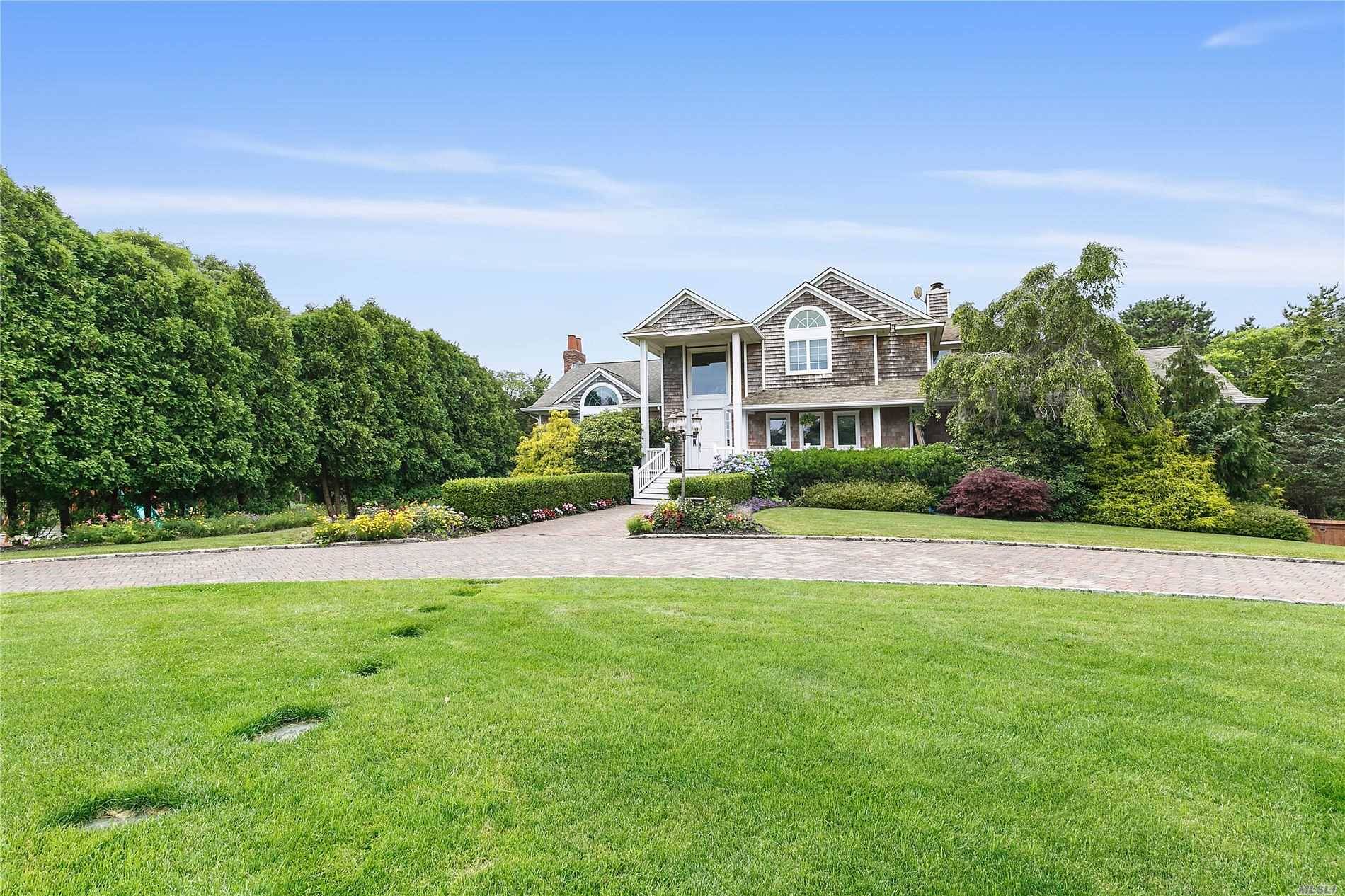 Situated on nearly 2. 8 secluded acres of luscious grounds in Westhampton sits this stunning Post Modern.