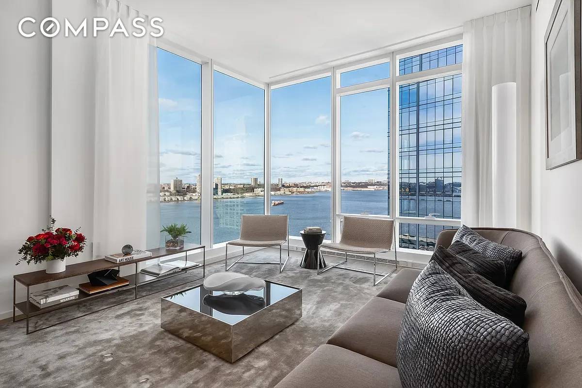 This spectacular corner two bedroom, two and a half bathroom residence at Two Waterline Square enjoys floor to ceiling windows with dramatic Hudson River views.