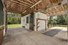Center-aisle barn featuring matted stalls with movable walls and automatic waterers