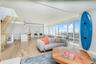 Living area featuring light wood-style flooring, a city view, and stairs