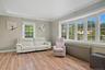 Living room featuring ornamental molding, radiator, and light wood finished floors