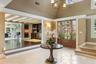 Entrance foyer featuring stairs, beamed ceiling, and a chandelier