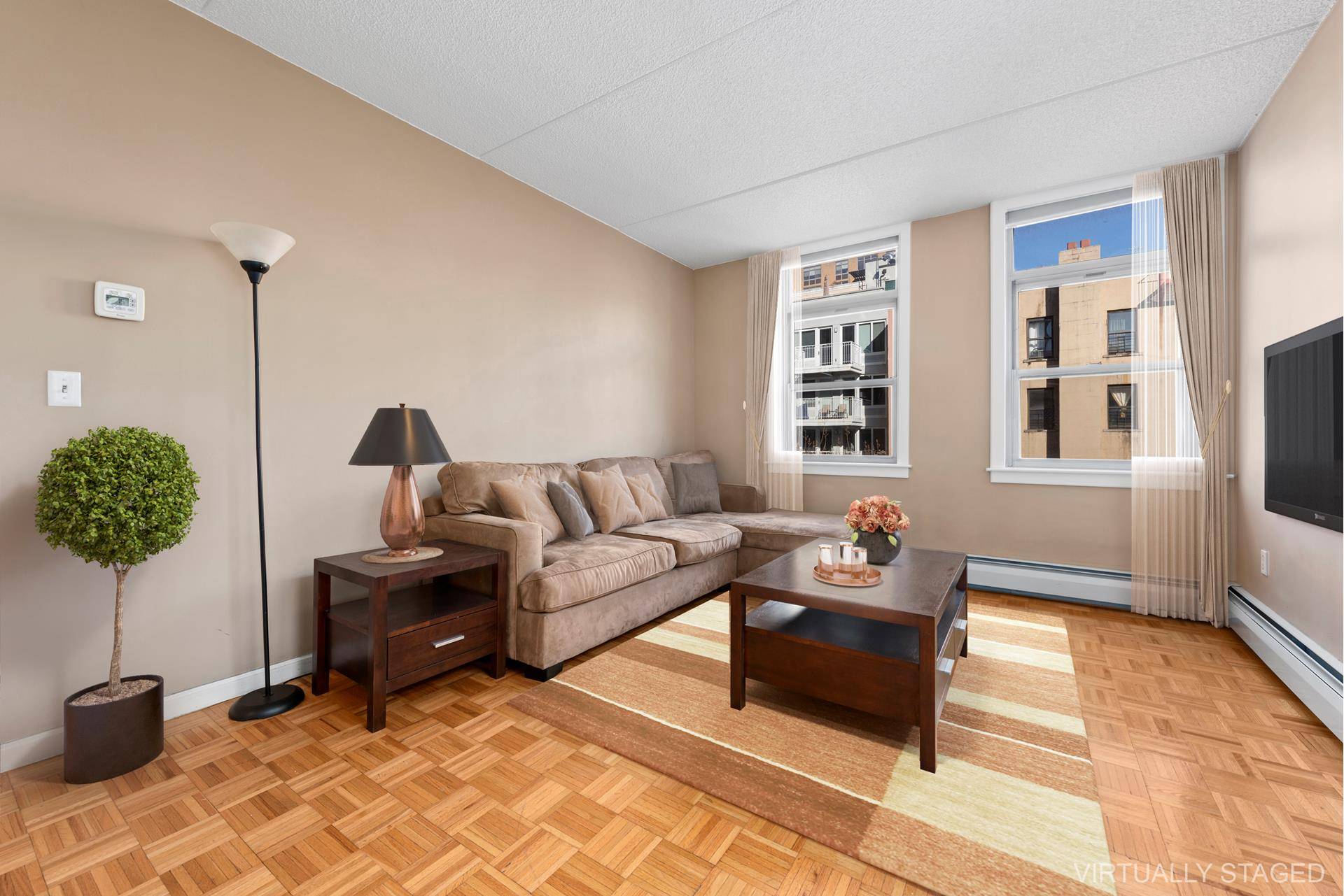 Corner 2 bedroom, 2 full bathroom unit at The Sutton boasting 8' 8 inch high ceilings, wood floors, comparable large bedrooms, an open windowed eat in kitchen featuring a dishwasher ...
