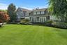 View of front of home with a chimney and a front lawn
