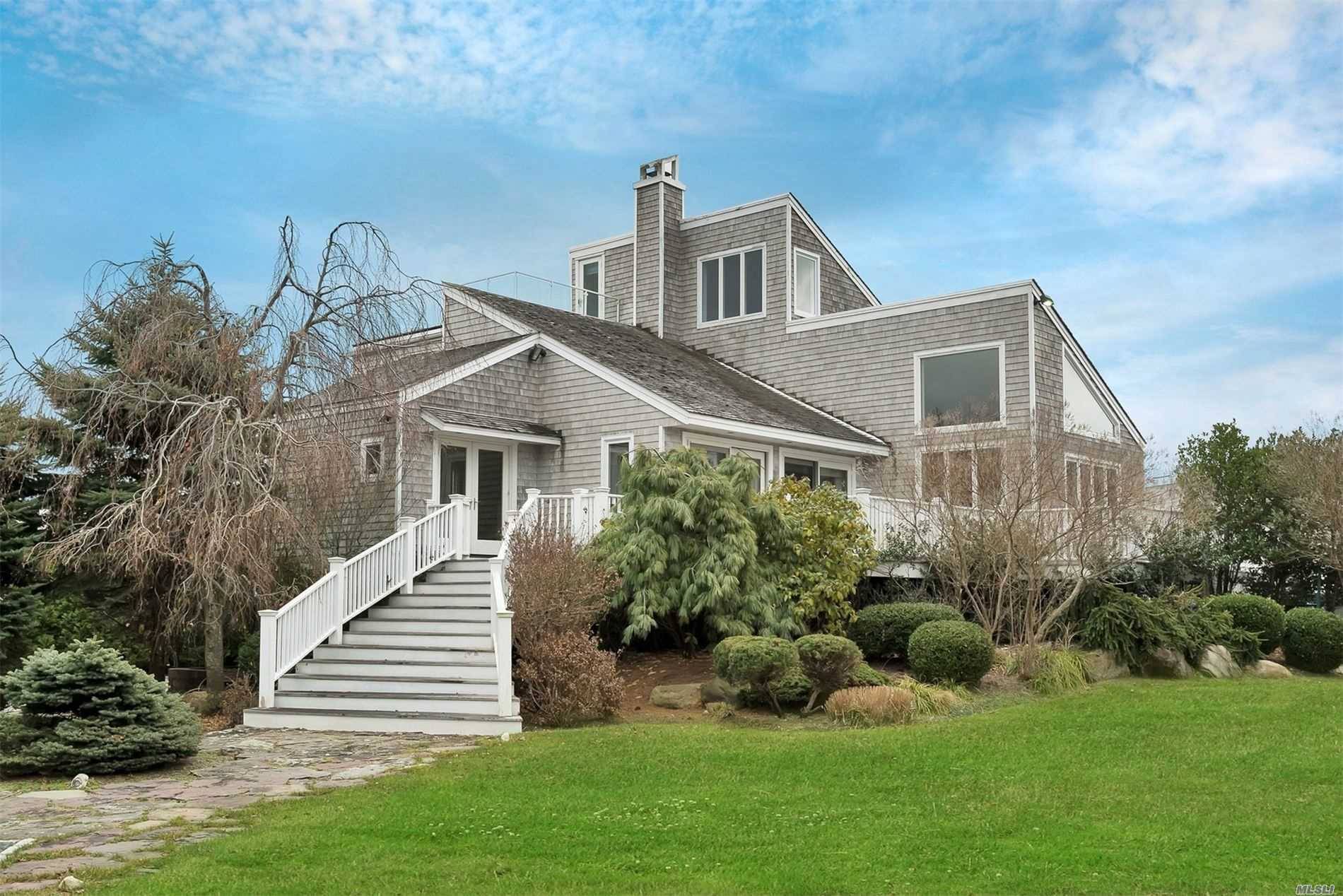 Handsome and spacious Contemporary home on the water in the highly desired Village of Quogue.