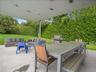 View of patio featuring outdoor dining area, outdoor lounge area, area for grilling, and view of wooded area