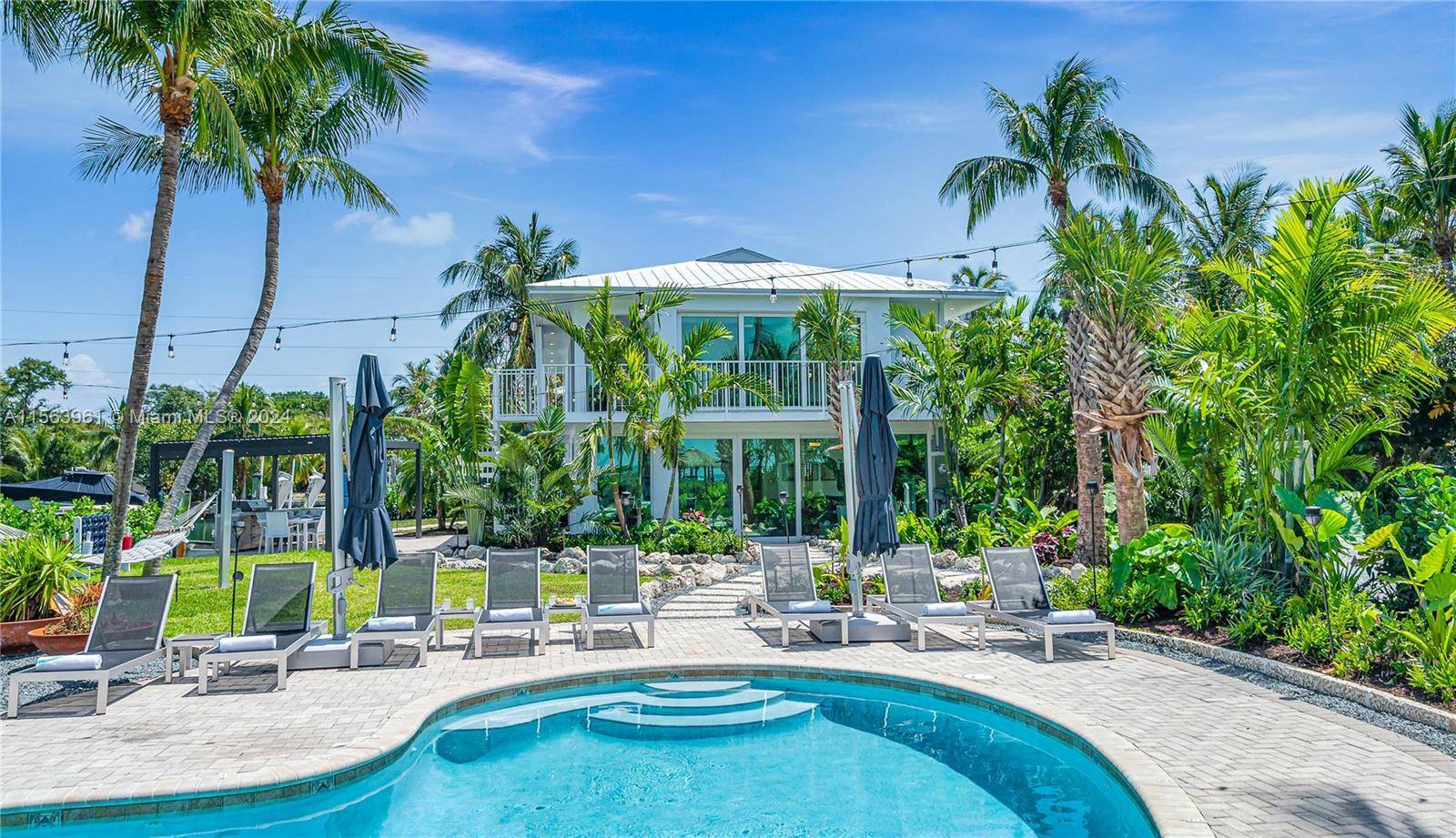 This grand peninsula retreat is embraced by the Ocean and lush mangroves, offering privacy to the heated pool with its tiki bar, expansive sandy playgrounds and lounge areas.