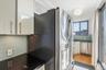 Kitchen featuring decorative backsplash, stainless steel appliances, white cabinetry, and light wood finished floors