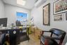 Home office featuring a paneled ceiling and an AC wall unit