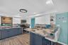 Expansive kitchen with barstool space and open layout.