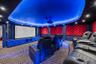 Carpeted cinema room featuring a raised ceiling, a decorative wall, and recessed lighting