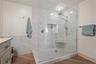 Anchored by an oversized walk-in shower