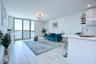 Living room featuring a water view, recessed lighting, light wood finished floors, and a notable chandelier