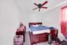 Bedroom with radiator heating unit and a ceiling fan