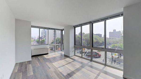 Spectacular 2 bedroom with dramatic corner living room windows, an open windowed kitchen with eating bar, split bedrooms, wood floors and an in unit washer dryer.