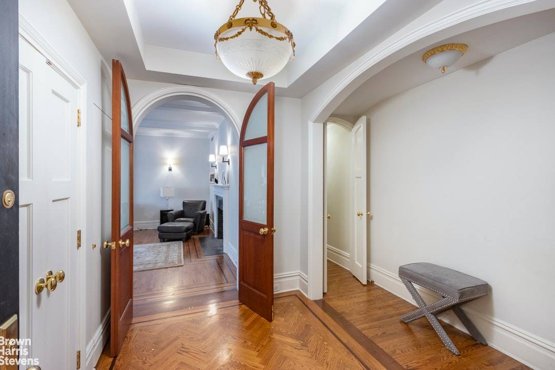 Entering through a gracious foyer into the grand living room with wood burning fireplace, bordered by a charming wood paneled library home office with fireplace and custom cabinetry and formal ...