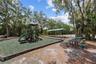 Community playground with picnic area and mature trees.