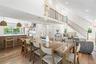 Dining room with recessed lighting, light wood-style floors, and a towering ceiling