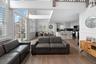 Living room with dark hardwood / wood-style flooring, sink, a towering ceiling, and french doors