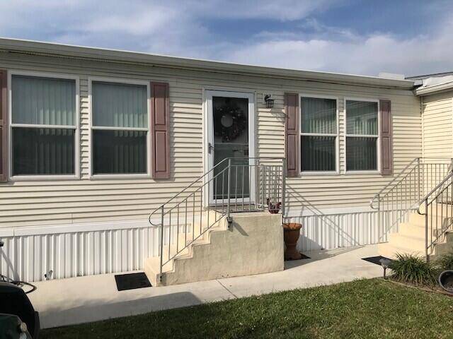 Beautiful well maintained 3 bedroom 2 bath manufactured home in Spanish Lakes Community with lake views.