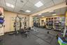 Dedicated fitness room featuring recessed lighting, a drop ceiling, and large windows