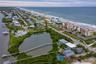 This rare barrier island location offers the best of both worlds: direct oceanfront living on one side and serene riverfront beauty on the other, all