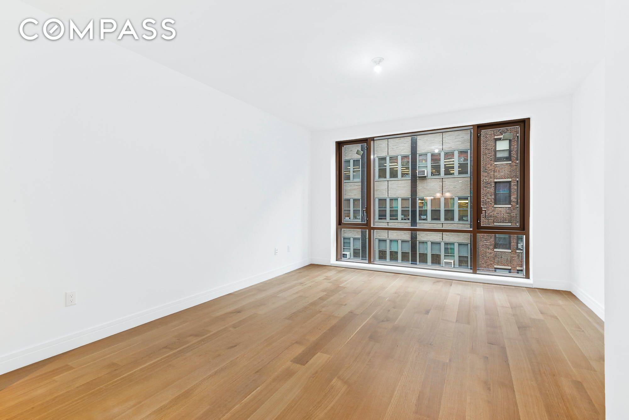 This brand new one bedroom at Gramercy Square has high ceilings, floor to ceiling windows and white oak flooring throughout with white lacquer cabinetry, a polished glass countertop and backsplash.