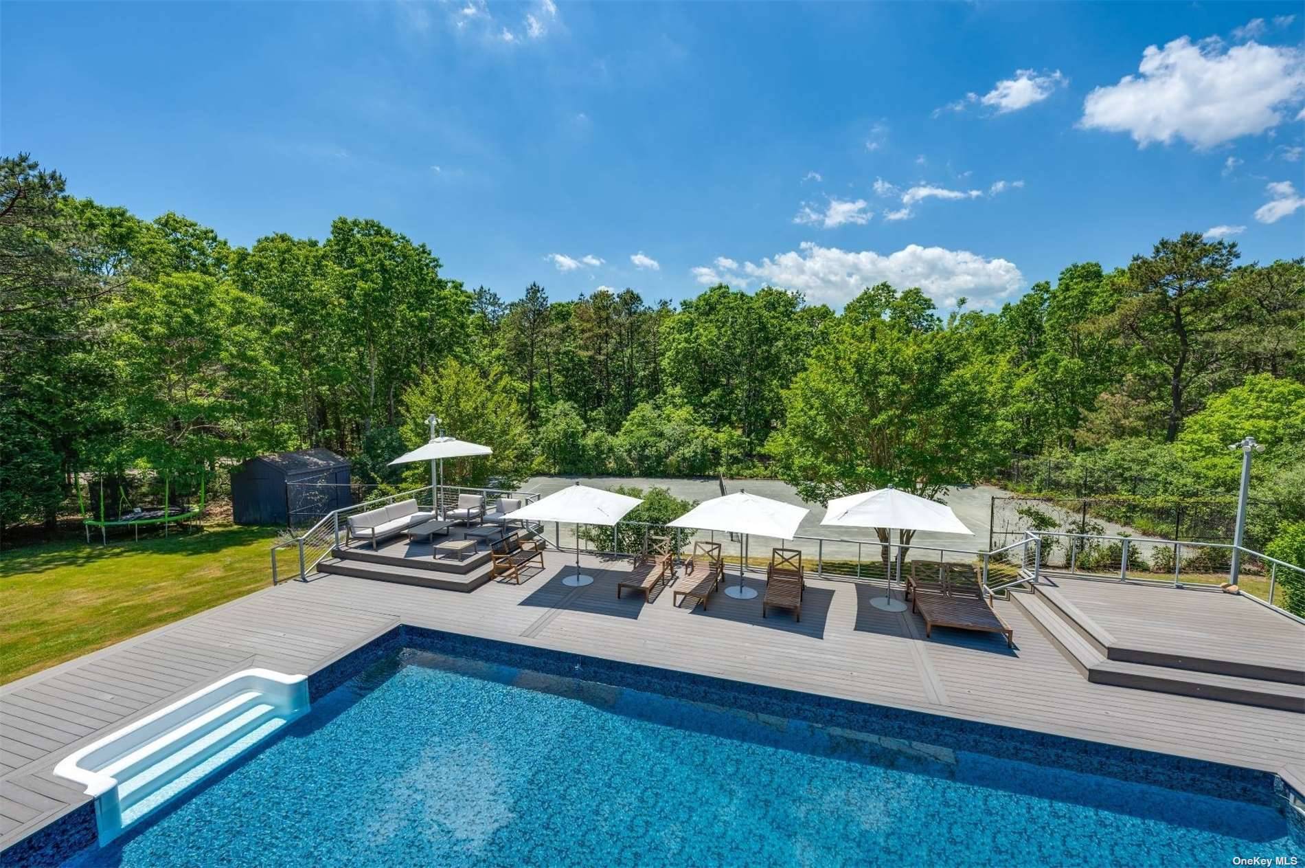 Modern Contemporary with Pool and Tennis On a quiet street in East Quogue sits this ideal getaway with pool and Har tru tennis court.