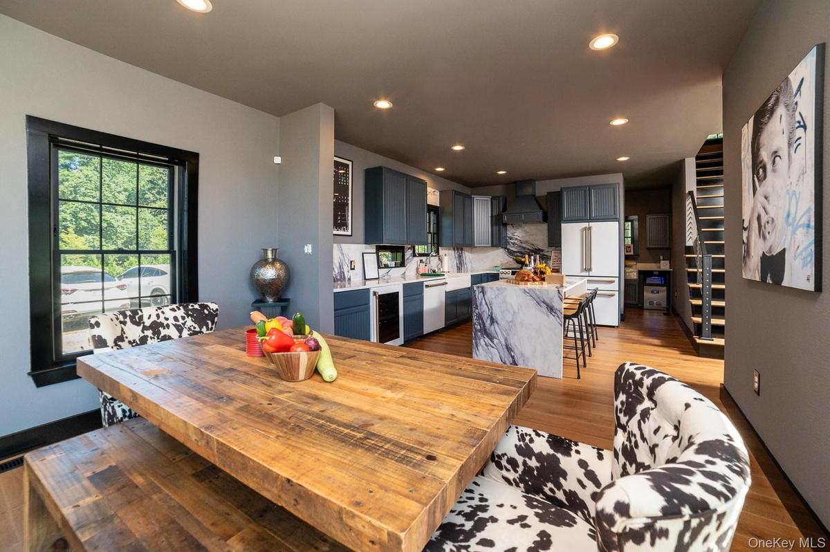 Dining room featuring light wood-style flooring, wine cooler, and recessed lighting