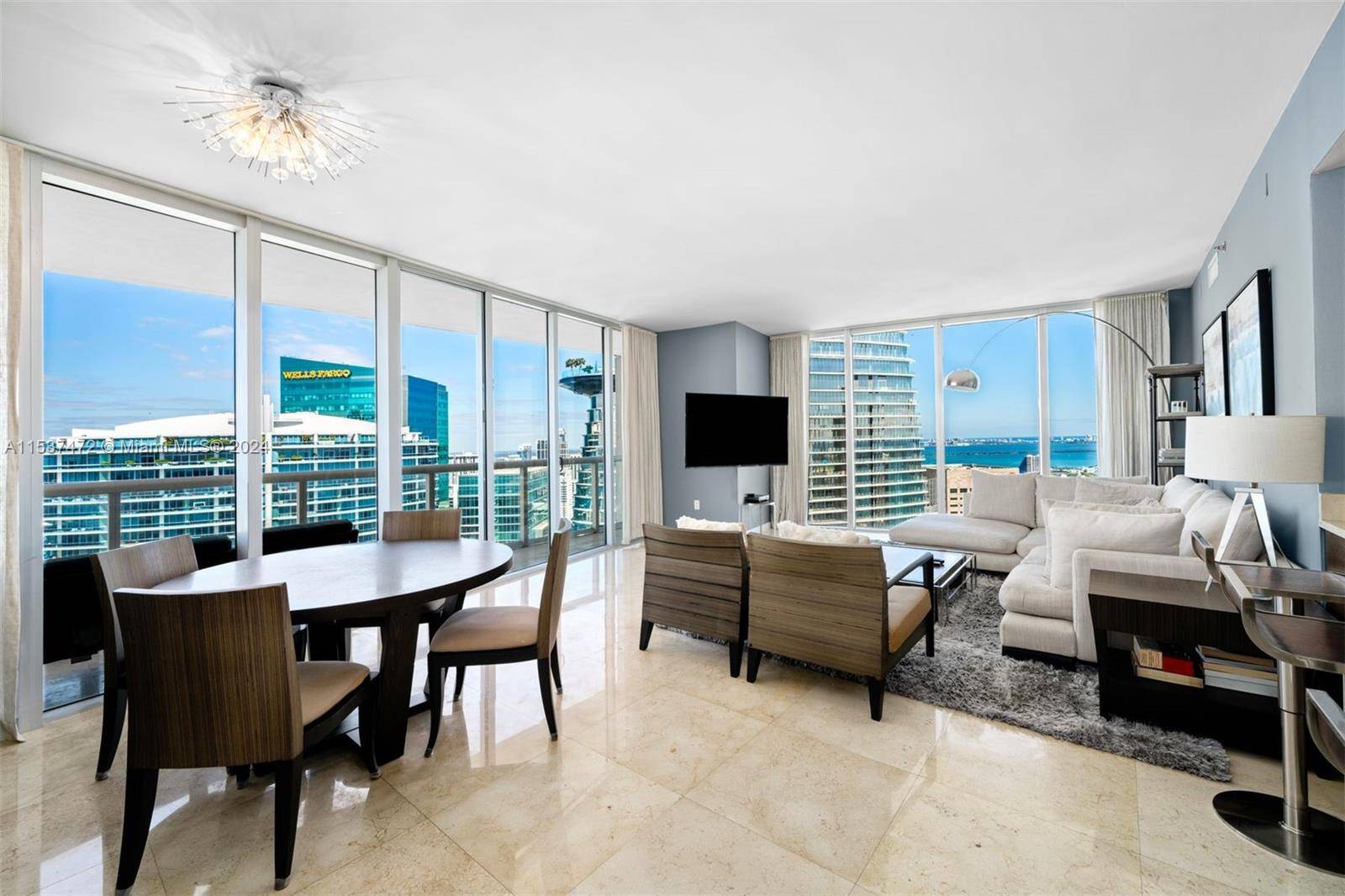 A beautifully furnished 2 Bed, 2 Bath condo at Icon Brickell Tower 1 featuring marble flooring throughout the main living areas, wood flooring in both bedrooms, high end kitchen appliances ...