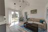 large open room with sunshine and a view of the water