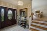 Entryway featuring a dark wood door with oval leaded glass, side panel windows, and a drum-style chandelier