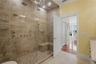 Luxurious primary bath featuring a spacious spa-inspired shower with sleek modern finishes