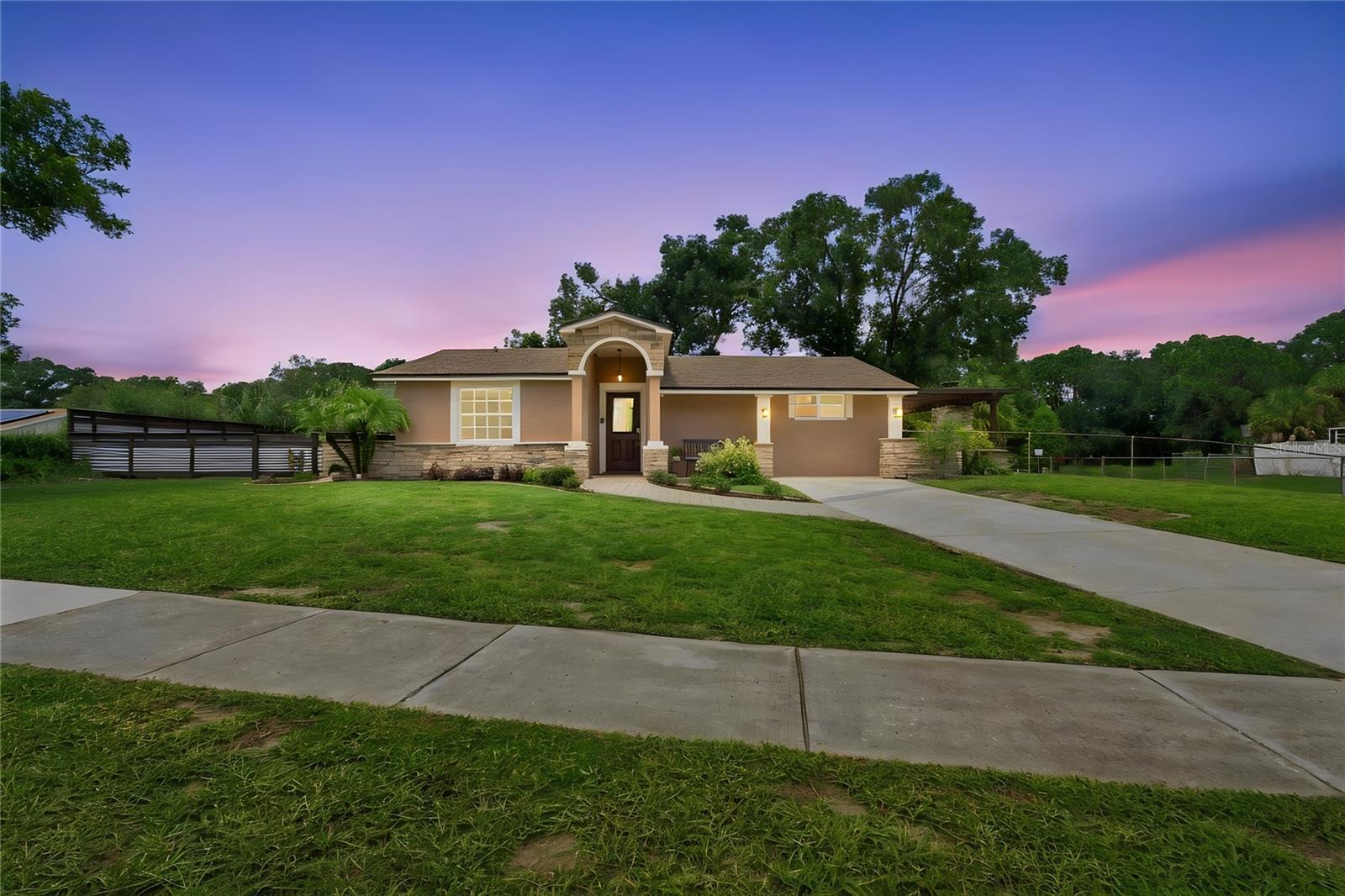 Front View warm color stone decor blends for a cohesive upgrade look, with Portico and Porch, paved walkway to complete the beautiful curb appeal.