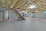 Unfinished basement featuring exposed wood joists with insulation, painted concrete flooring, a utility sink, and a water heater