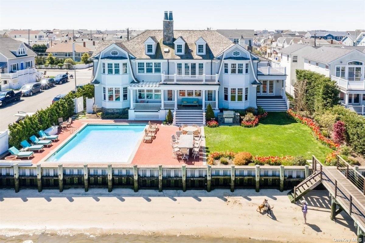 Spectacular Hamptons Like Mansion Located On Reynolds Channel With Picturesque City Skyline Views amp ; Amazing Sunsets.