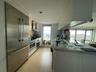 Kitchen with a wealth of natural light, backsplash, wall chimney exhaust hood, stainless steel appliances, and light wood-style floors